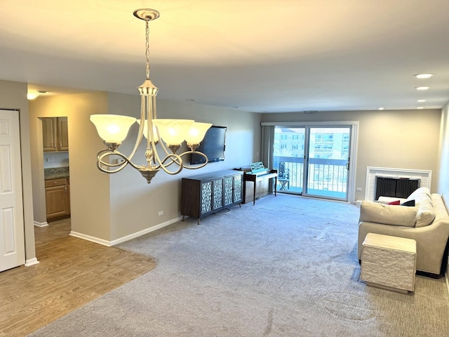 carpeted living room with a notable chandelier