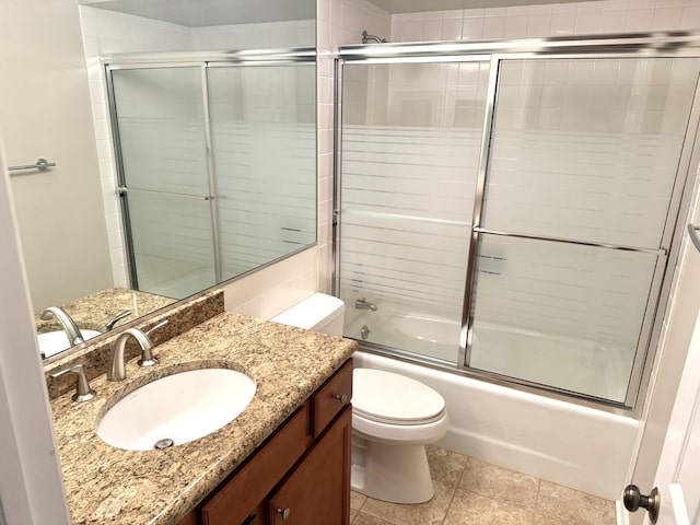 full bathroom featuring vanity, enclosed tub / shower combo, and toilet