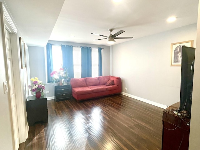 living room with dark hardwood / wood-style floors and ceiling fan