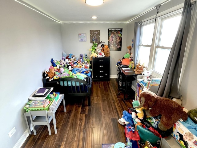 bedroom with dark hardwood / wood-style floors