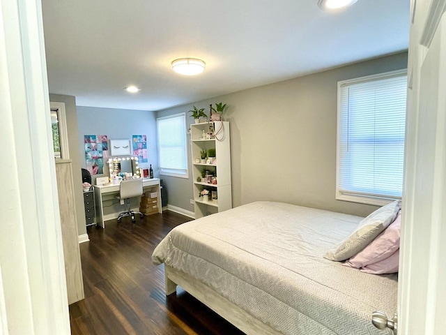 bedroom with dark hardwood / wood-style floors