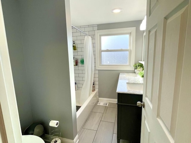 full bathroom featuring vanity, shower / tub combo, and toilet