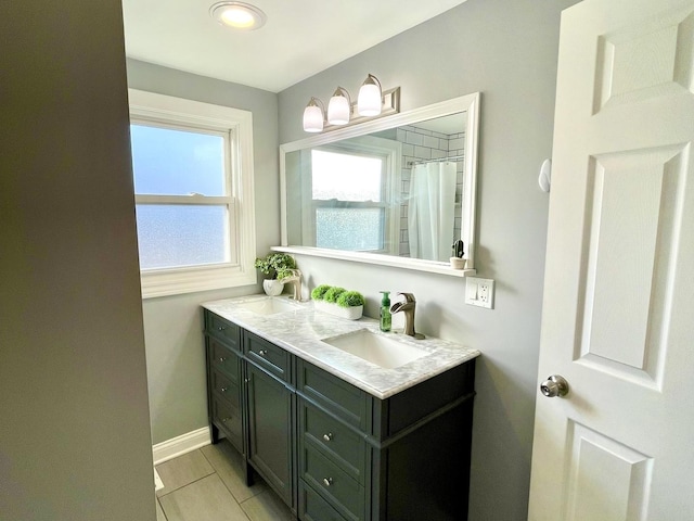 bathroom with vanity, tile patterned flooring, and curtained shower