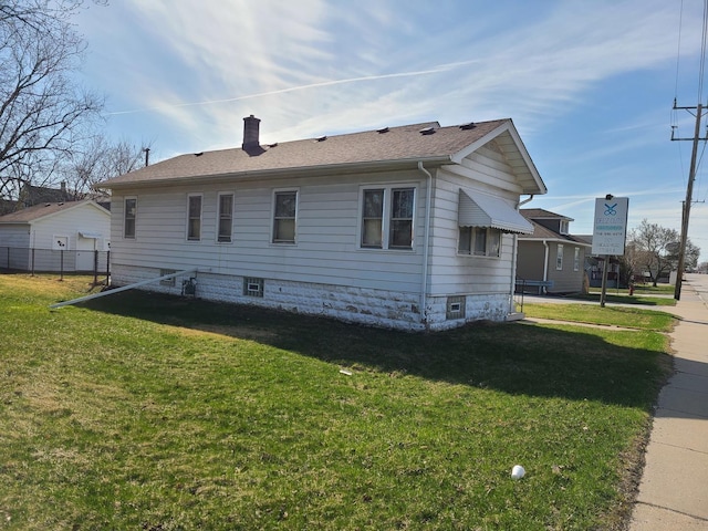 back of property featuring a lawn