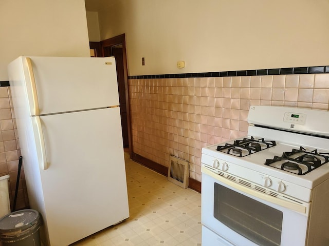 kitchen with tile walls and white appliances