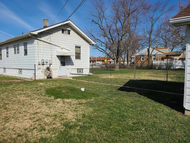 back of property featuring a yard