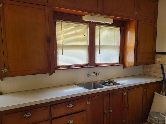 kitchen featuring tasteful backsplash and sink