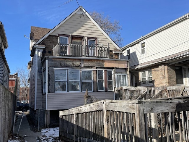 rear view of house featuring a balcony