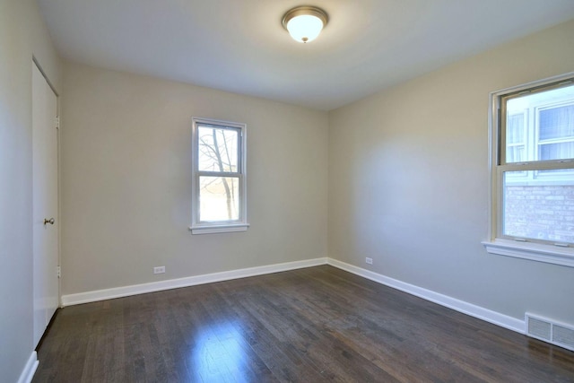 empty room with dark wood-type flooring