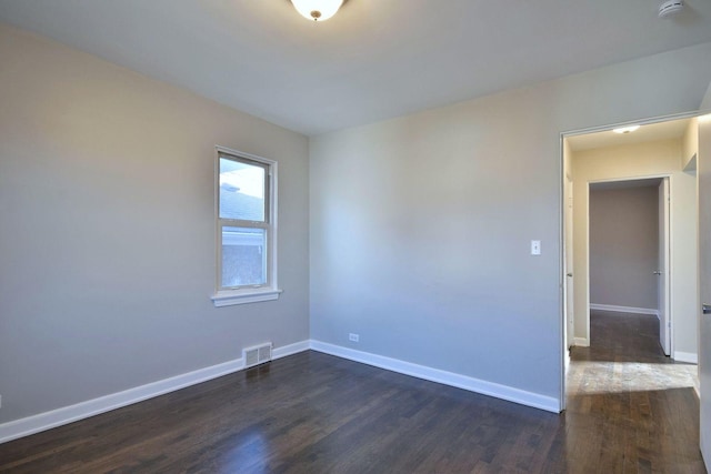 spare room featuring dark hardwood / wood-style flooring