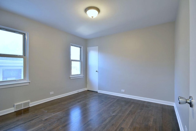 spare room featuring dark hardwood / wood-style floors