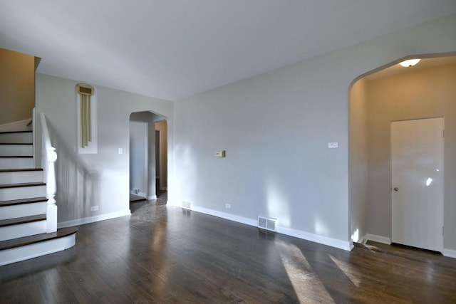 unfurnished living room featuring dark hardwood / wood-style flooring