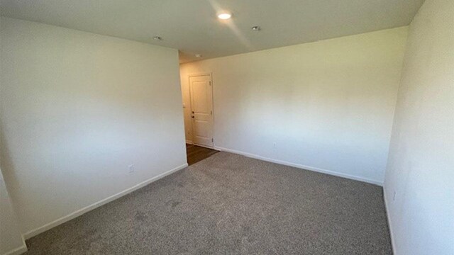 spare room with carpet flooring, recessed lighting, and baseboards