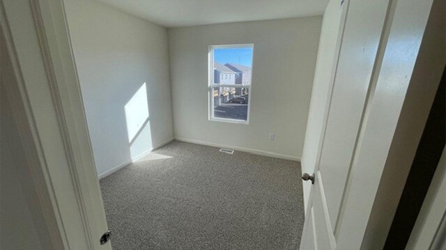 unfurnished bedroom featuring baseboards and carpet flooring