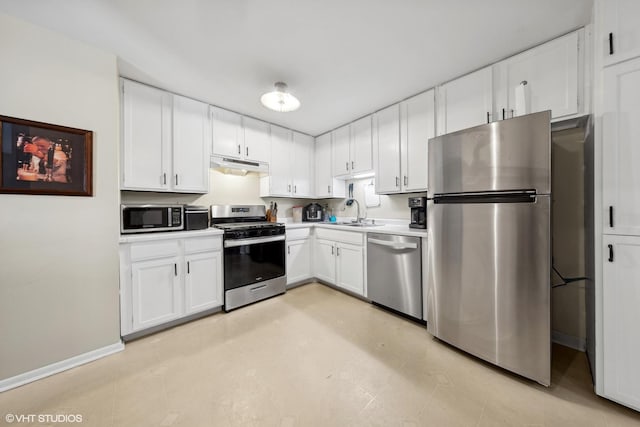 kitchen with stainless steel appliances, sink, and white cabinets