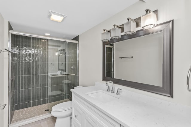 bathroom featuring vanity, tile patterned flooring, toilet, and walk in shower