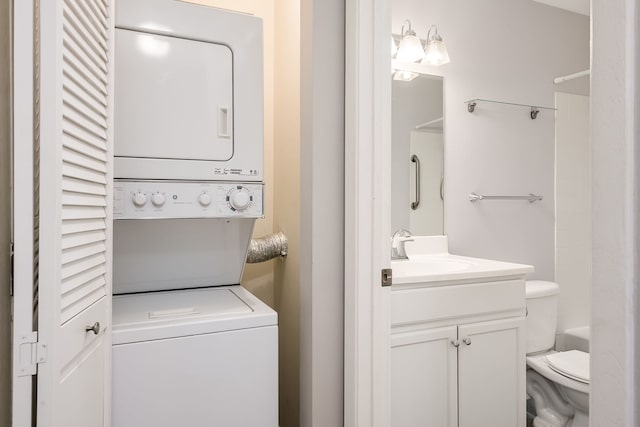 clothes washing area with a sink and stacked washing maching and dryer