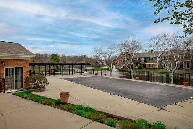 view of pool featuring fence