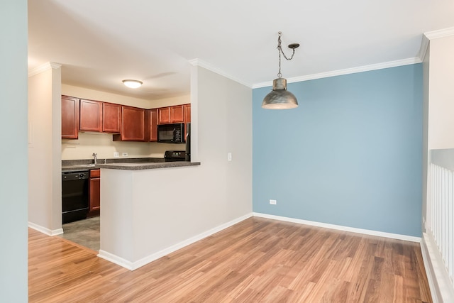 kitchen featuring black appliances, dark countertops, crown molding, and light wood finished floors