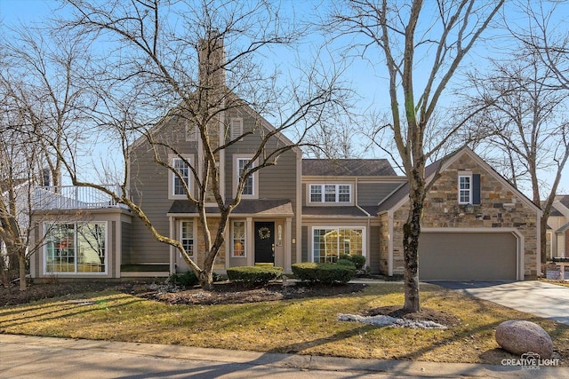 view of front of property with a garage, stone siding, and concrete driveway