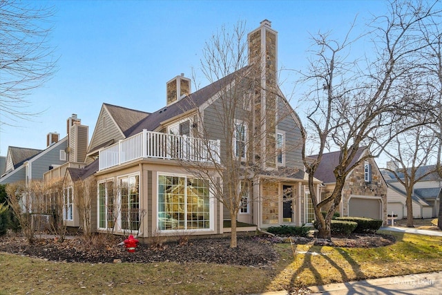 view of front of home featuring a garage and a balcony