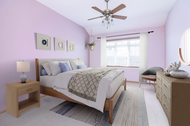 bedroom featuring light carpet, baseboards, vaulted ceiling, and a ceiling fan