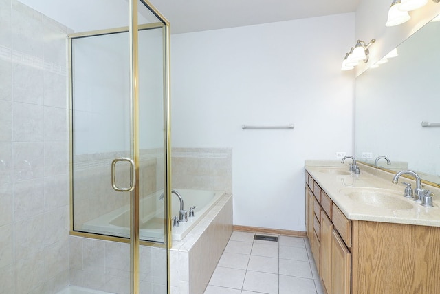 full bath featuring a bath, tile patterned flooring, and a sink