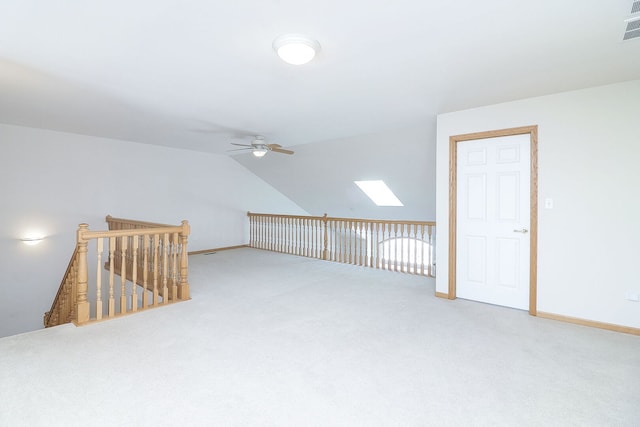 bonus room featuring lofted ceiling, carpet flooring, ceiling fan, and baseboards