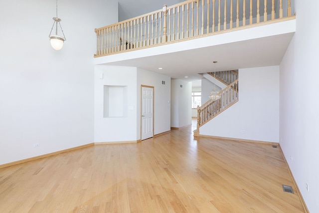 unfurnished room with visible vents, baseboards, and wood finished floors