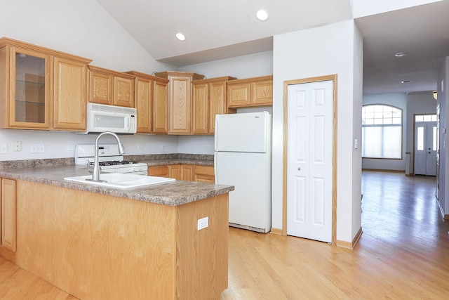 kitchen with light wood finished floors, recessed lighting, glass insert cabinets, white appliances, and a peninsula