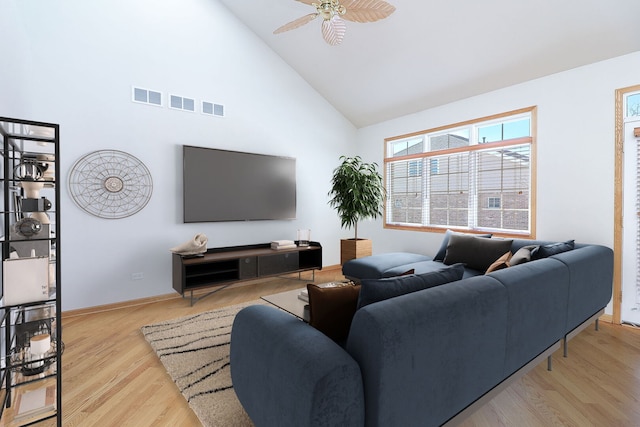 living room with visible vents, a ceiling fan, wood finished floors, high vaulted ceiling, and baseboards