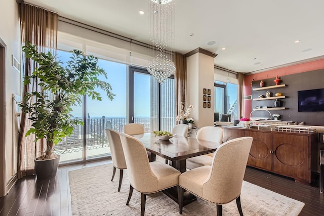 dining room featuring floor to ceiling windows, dark hardwood / wood-style floors, and a chandelier