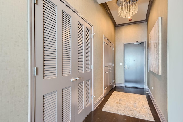 doorway with a notable chandelier and crown molding