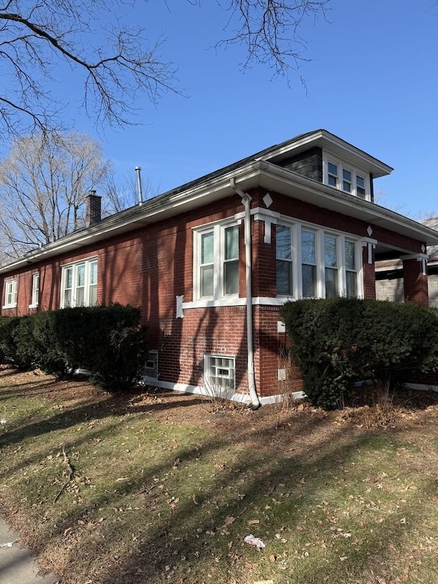 view of side of home featuring a lawn