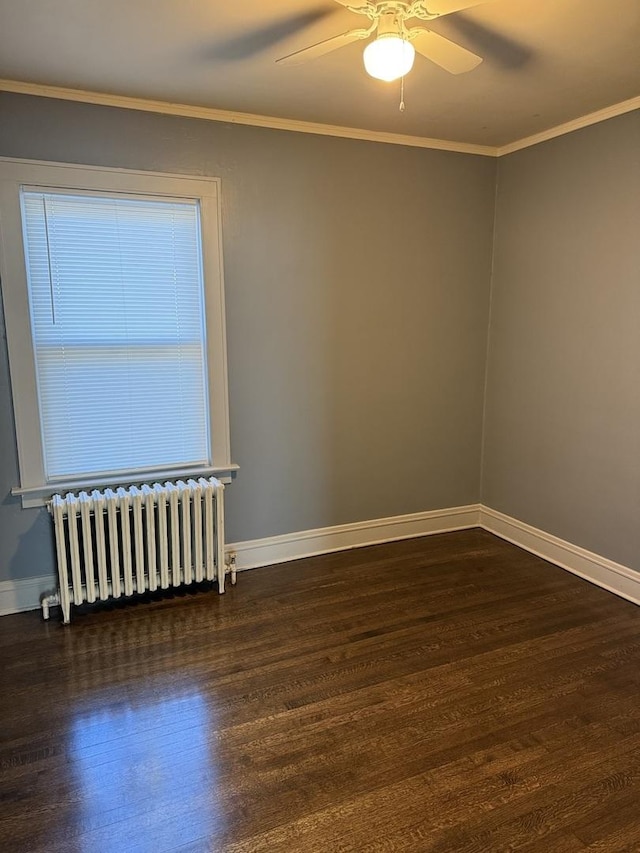 spare room featuring crown molding, radiator heating unit, dark hardwood / wood-style floors, and ceiling fan