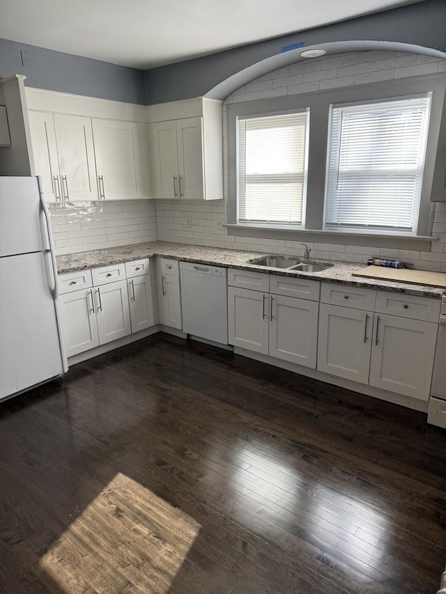 kitchen with white cabinetry, sink, white appliances, and dark hardwood / wood-style flooring