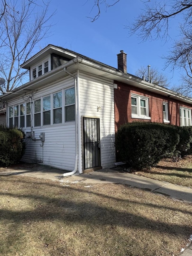 view of side of home with a lawn