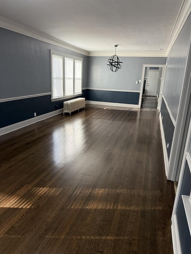 unfurnished room with crown molding, dark hardwood / wood-style floors, and radiator heating unit