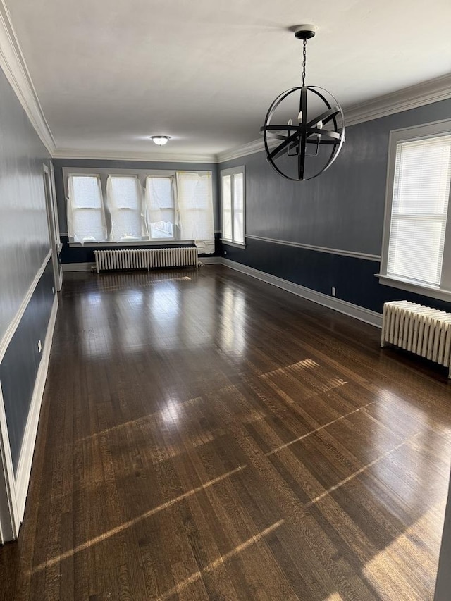 interior space featuring plenty of natural light, radiator, and a notable chandelier