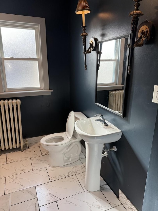 bathroom with radiator heating unit and toilet