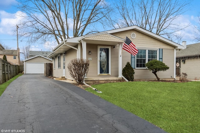 bungalow with an outbuilding, a garage, and a front yard