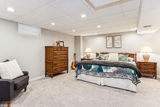 carpeted bedroom with a drop ceiling