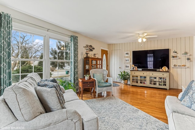 living room with hardwood / wood-style flooring and ceiling fan