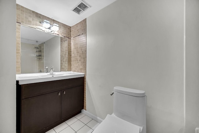 bathroom featuring vanity, tile patterned floors, and toilet