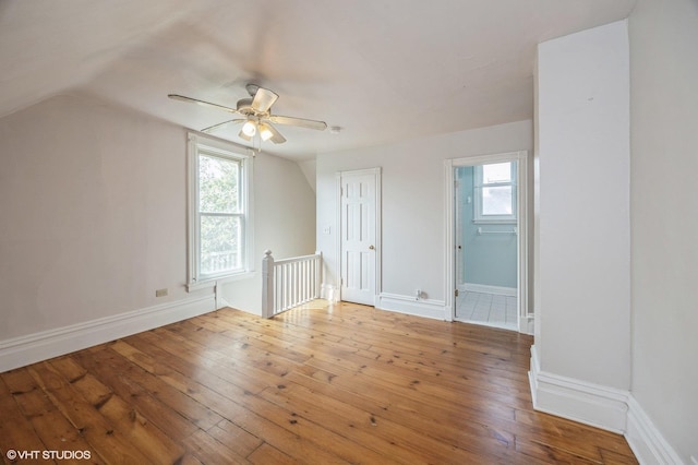 bonus room featuring ceiling fan, lofted ceiling, a healthy amount of sunlight, and hardwood / wood-style floors