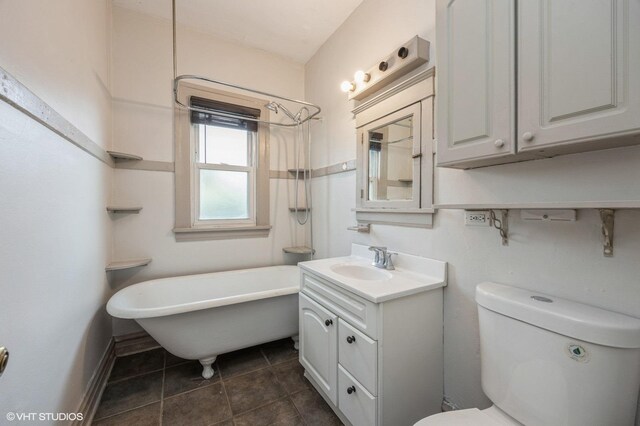 bathroom with vanity, a bathtub, and toilet