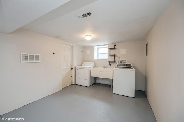 washroom with sink and washing machine and dryer