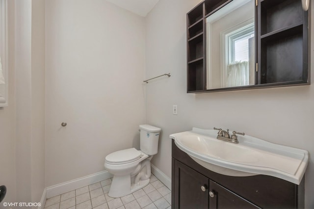 bathroom featuring vanity, tile patterned floors, and toilet