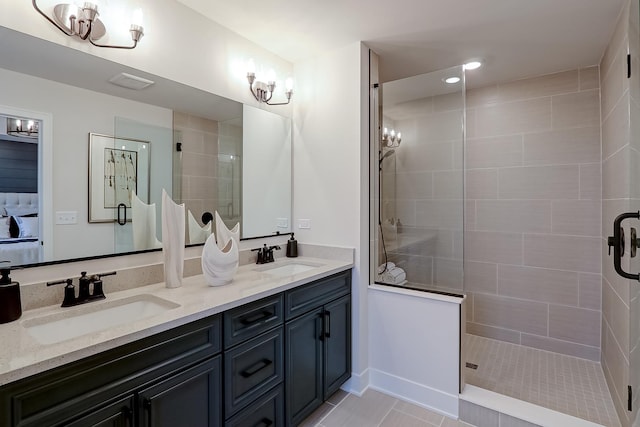 bathroom with vanity, a shower with door, and tile patterned flooring