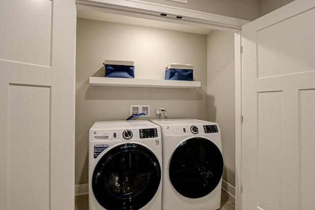 laundry area with tile patterned floors and washer and clothes dryer